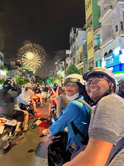 KISSTOUR| Saigon By Night & Street Food Tour on Motorbike - Ao dai guides, helmets, and rain ponchos: getting set up right